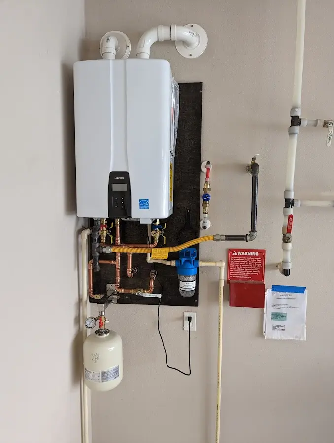 Professional plumber installing copper piping in a Attica home
